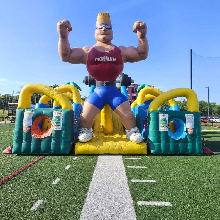 Inflatable Obstacle Course setup on turf sports field for an event in Rochester, NY.
