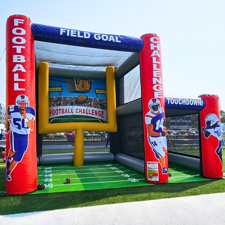 Inflatable football challenge game setup on a field before an event begins in Buffalo, New York.
