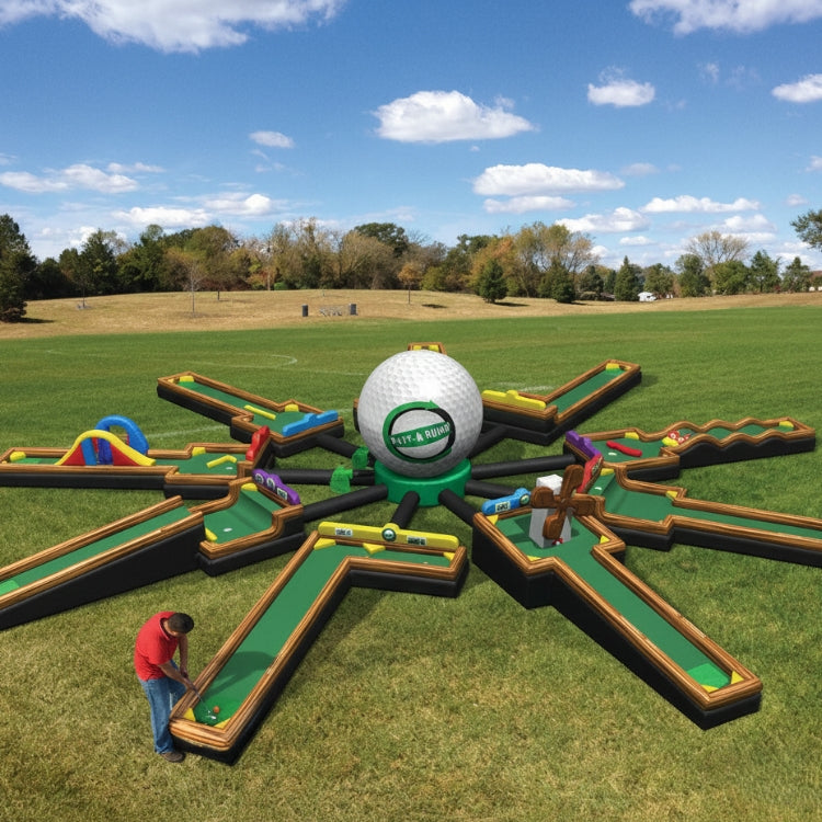 Miniature golf course with large inflatable ball and player on a grassy field.