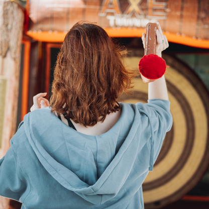 Player Throwing Axe While Playing Inflatable Axe Throwing Game