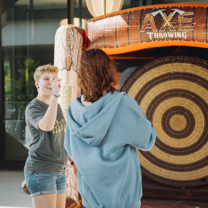 Two players having fun with the Inflatable Axe Throwing Game Rental