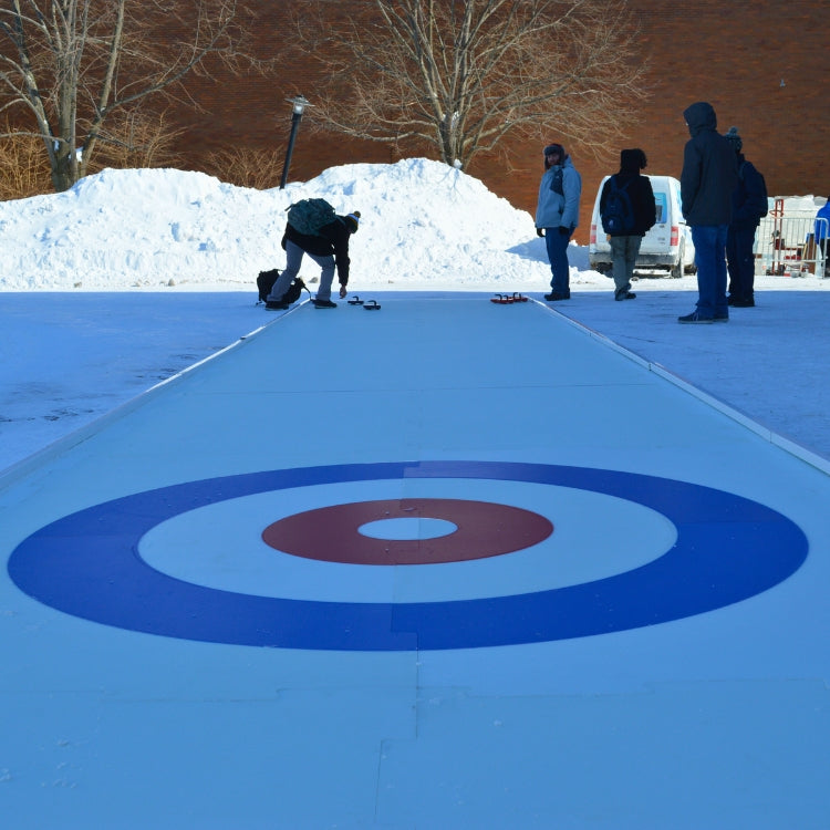 People playing curling on a mobile curling rink at a winter event in Rochester, NY.