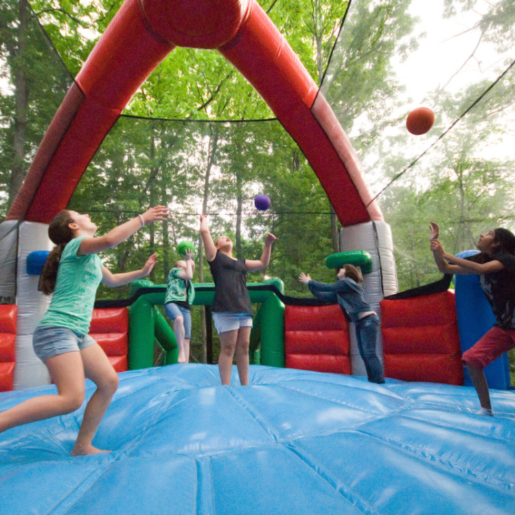 Five kids playing in the Defender Dome Inflatable Arena