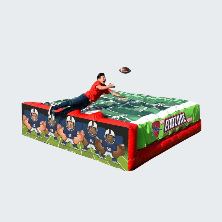 Inflatable football-themed landing pad featuring cartoon football players and a person catching a football mid-air.  