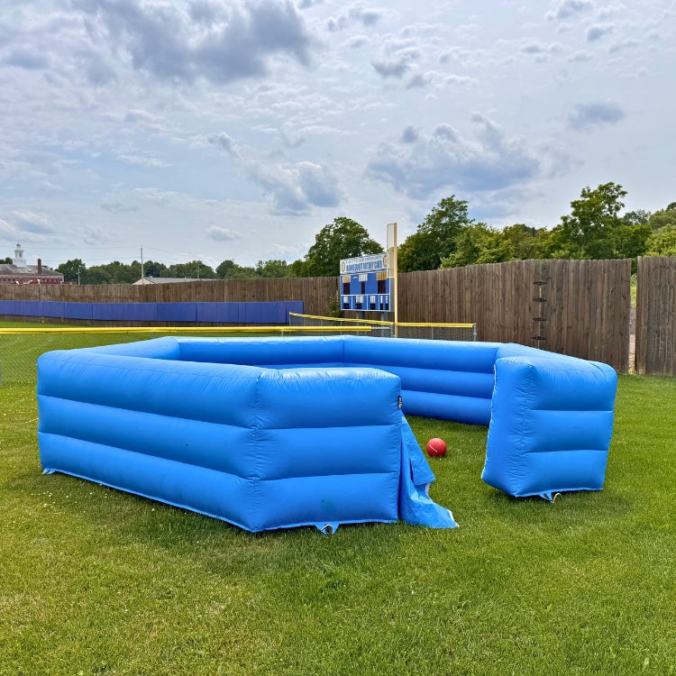 Inflatable Gaga Pit Game setup outdoors on a grassy field before an event begins in Rochester, NY.