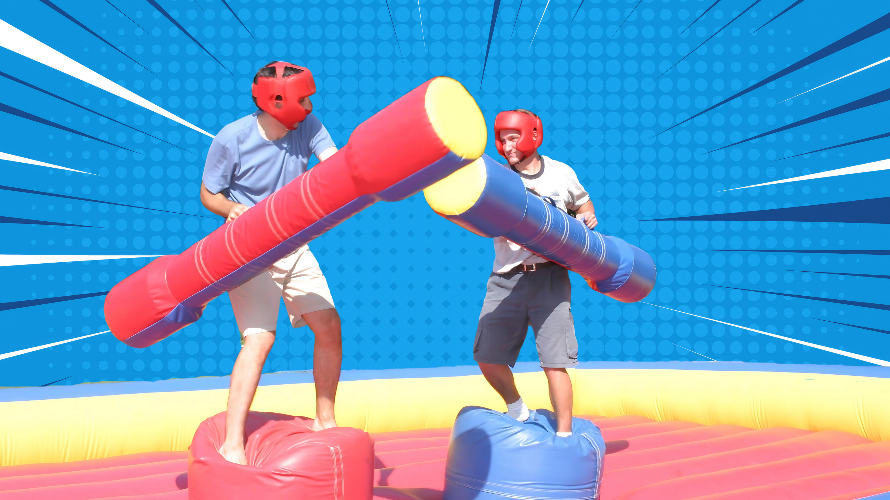 Two players competing on an inflatable jousting rental attraction in Rochester, NY.