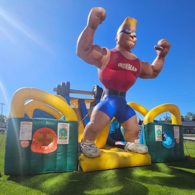 Large Inflatable Obstacle Course rental at outdoor event on sunny day with blue skies.