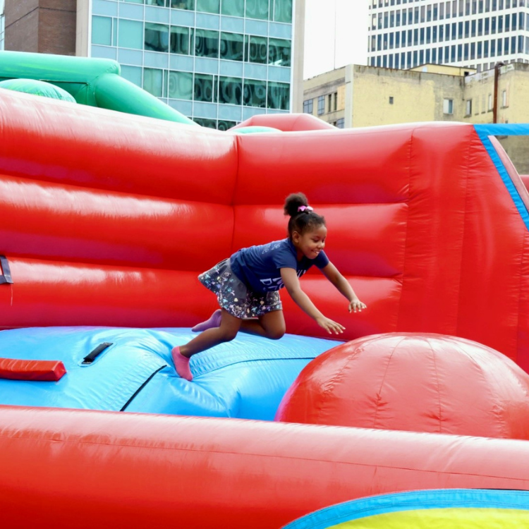 Girl Leaping on the Leaps & Bounds Inflatable Rental in Rochester, NY