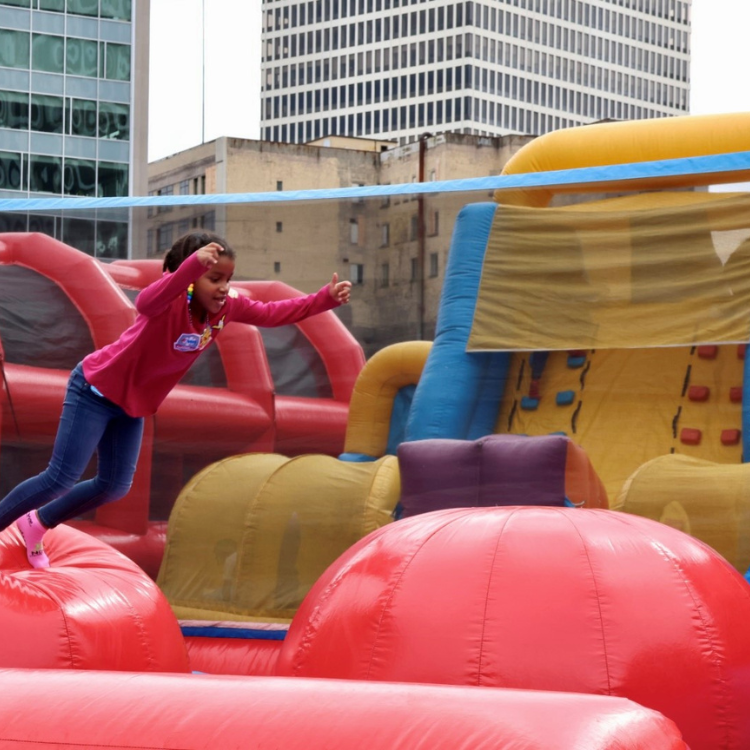 Girl About to Jump from Ball to Ball on the Leaps & Bounds Inflatable Rental in Rochester, NY