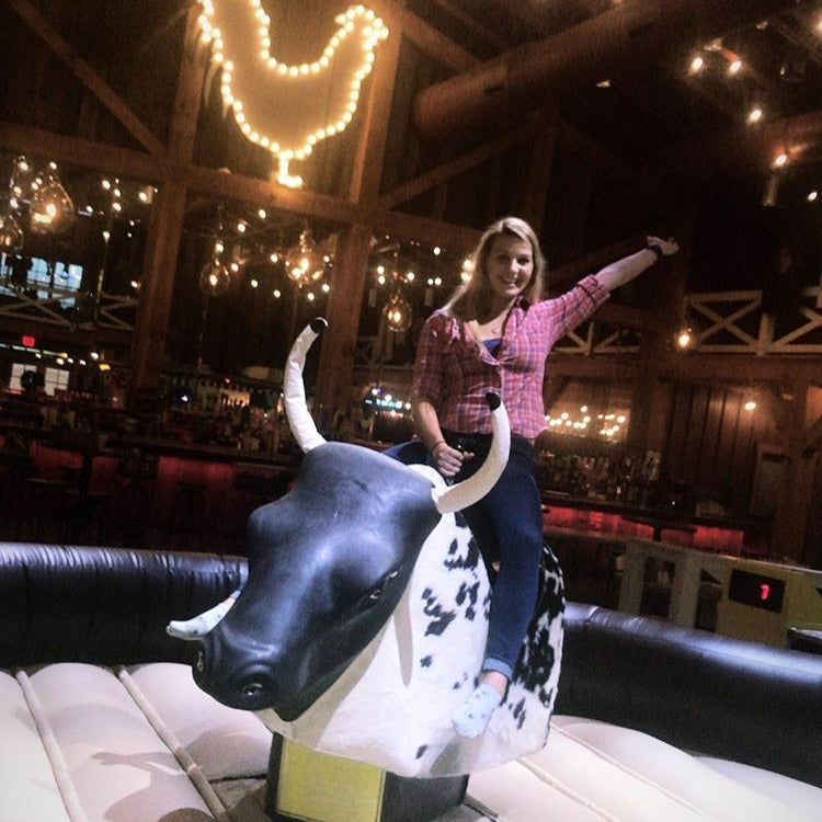 Woman Riding Mechanical Bull Rental in Syracuse, NY at Party