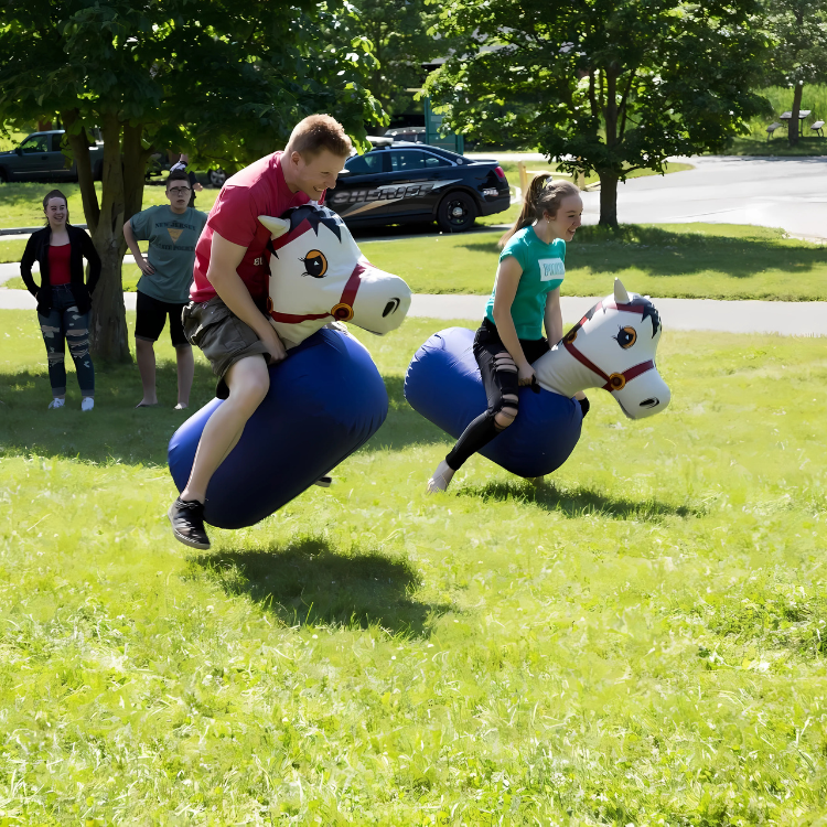 Two players riding inflatable pony hop rentals in Rochester, NY