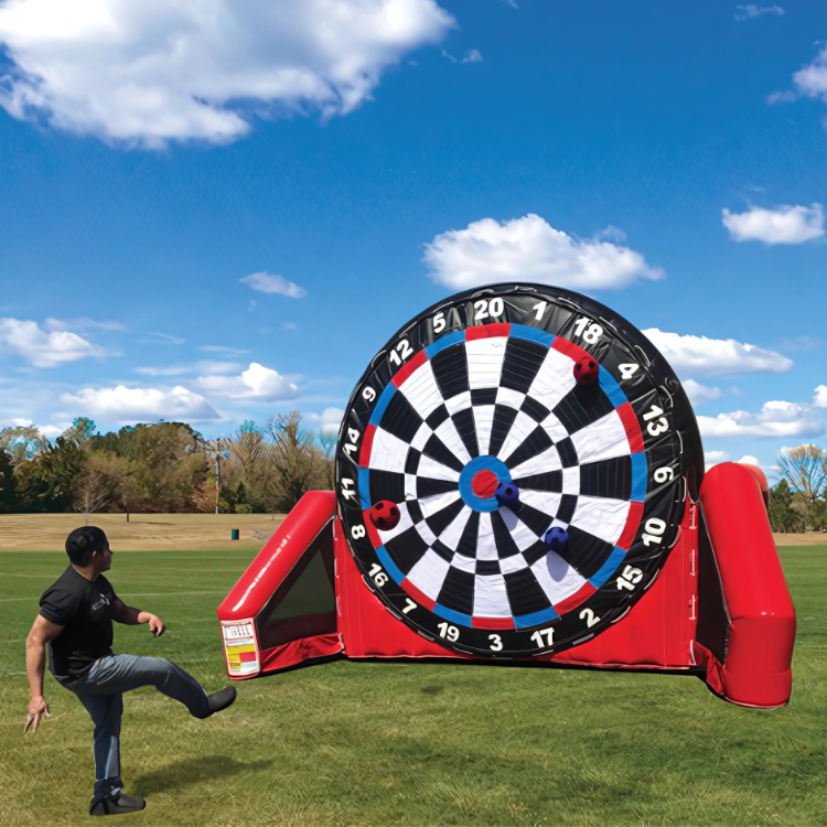 Person Playing the Inflatable Soccer Darts Game Rental Kicking Velcro Soccer Ball onto Velcro Dartboard in Rochester, NY