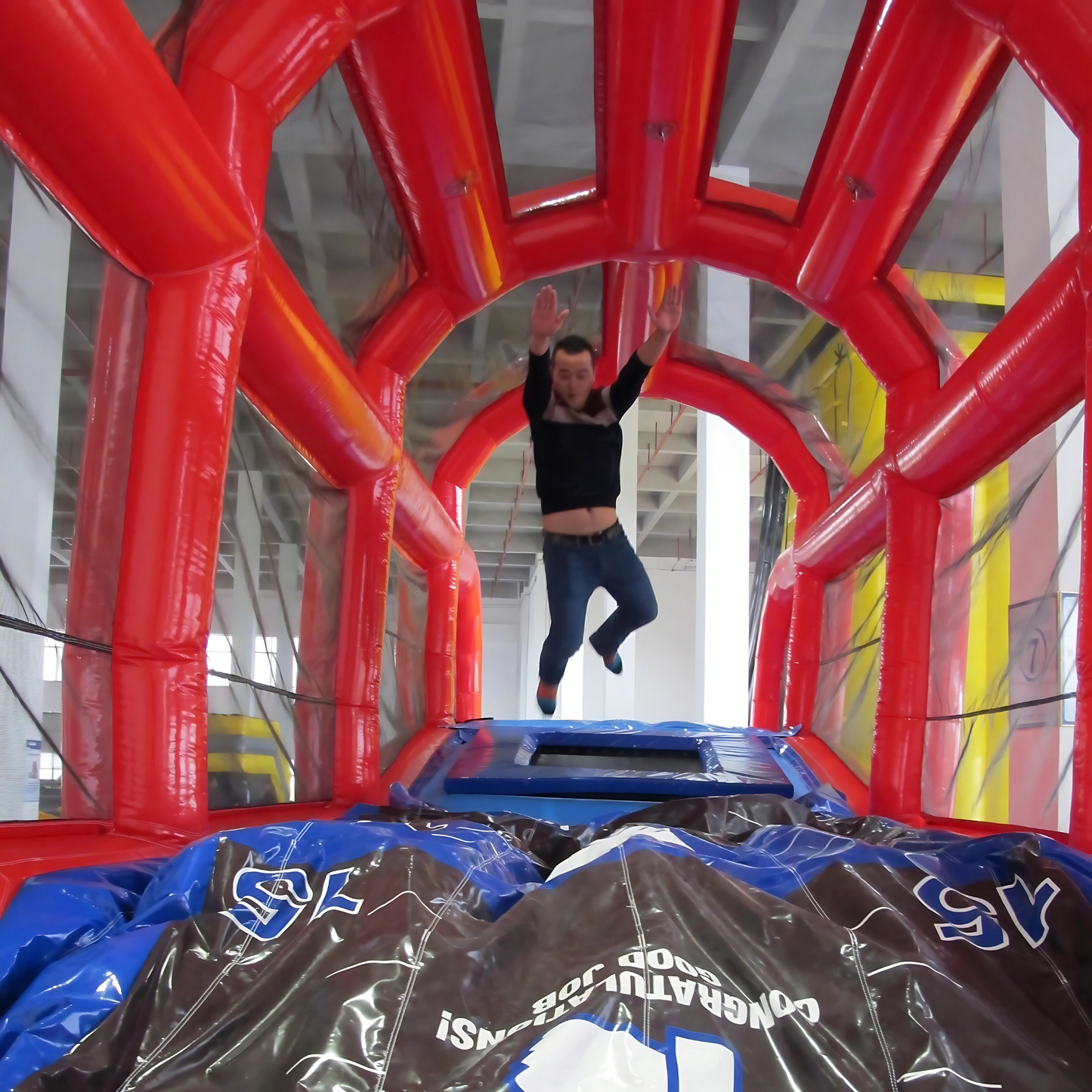 The Launch Pad Inflatable Rental with Participant Bouncing and Launching Through the Air