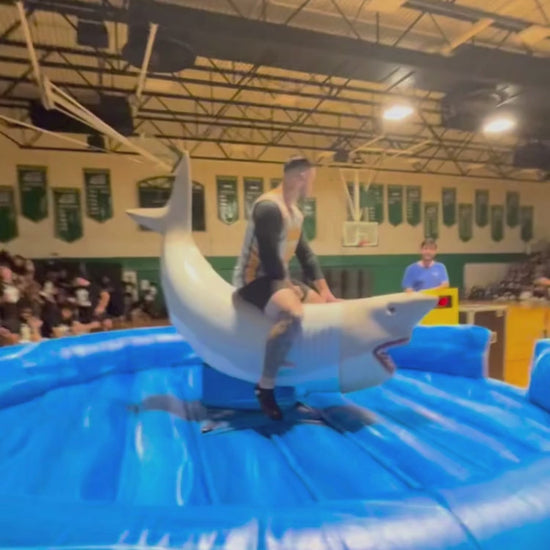 Man Riding Mechanical Shark Rental at Event in Finger Lakes Region, in New York State